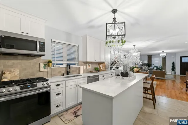 a kitchen with a stove a sink and a microwave