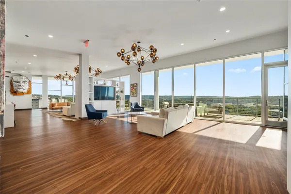 a view of a balcony with chairs and wooden floor
