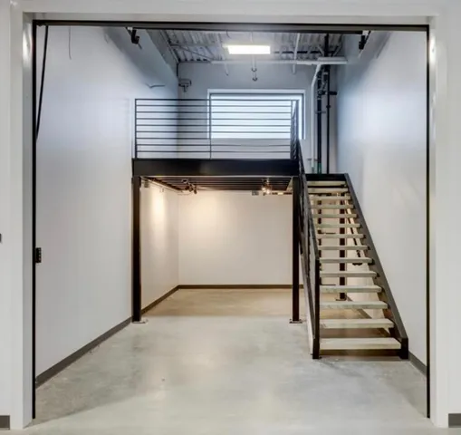a view of room with stairs and wooden floor