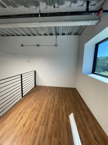 a view of a room with wooden floor