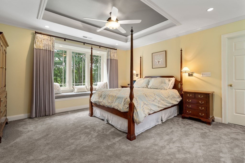 11 Equestrian Drive North Reading, MA 01864 - Photo 15 of 41 a bedroom with a large bed and a chandelier fan