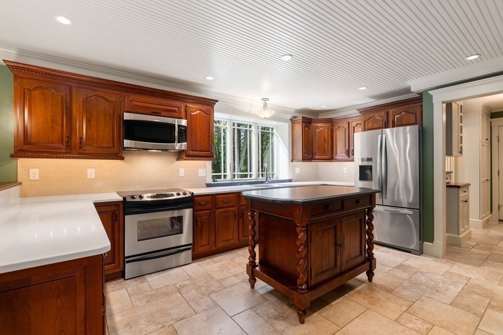 11 Equestrian Drive North Reading, MA 01864 - Photo 10 of 41 a kitchen with kitchen island granite countertop stainless steel appliances stove microwave refrigerator and sink