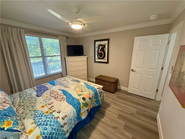 a bedroom with a bed a dresser and a window