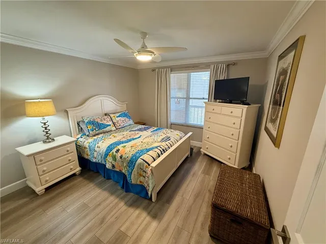 a bedroom with a bed and a television