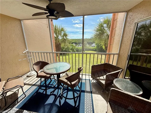 a view of a chairs and table in the balcony