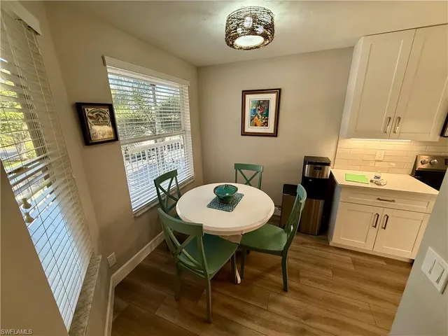 a view of a dining room with furniture and wooden floor