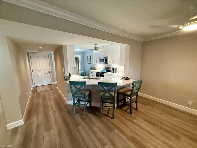a view of a dining room with furniture and wooden floor