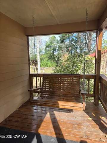 a view of a balcony with wooden floor