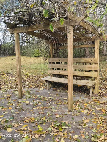 a view of a wooden fence and trees