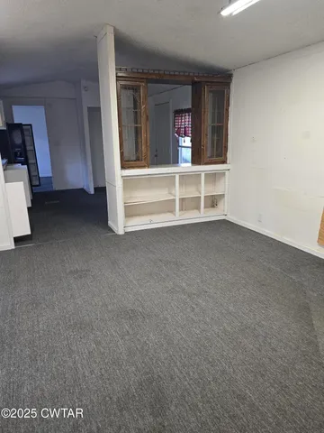 a view of an empty room with a fireplace