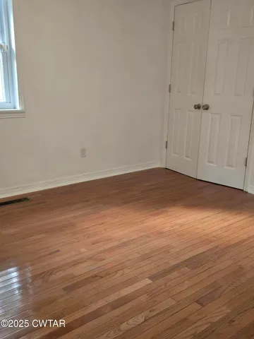 a view of a room with wooden floor