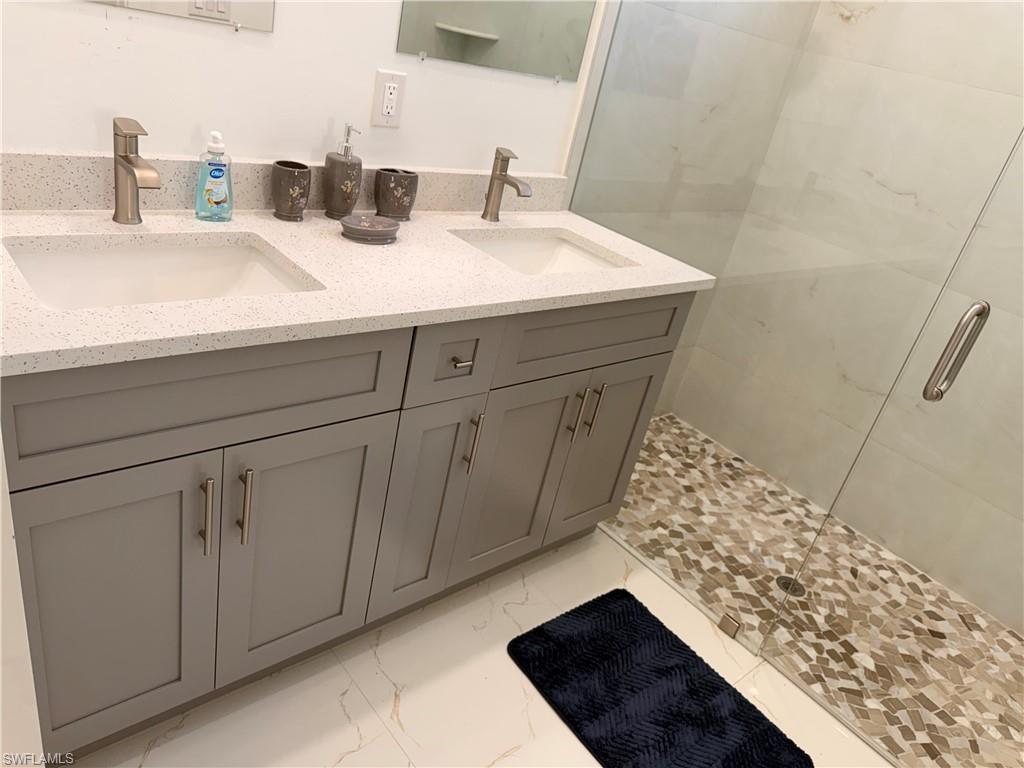 941 Columbus Boulevard Lehigh Acres, FL 33974 - Photo 12 of 41 a bathroom with a sink and a mirror