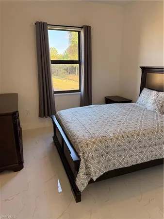 a bedroom with a bed and a mirror on dresser