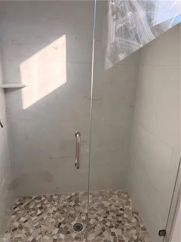a bathroom with a granite countertop toilet sink and mirror
