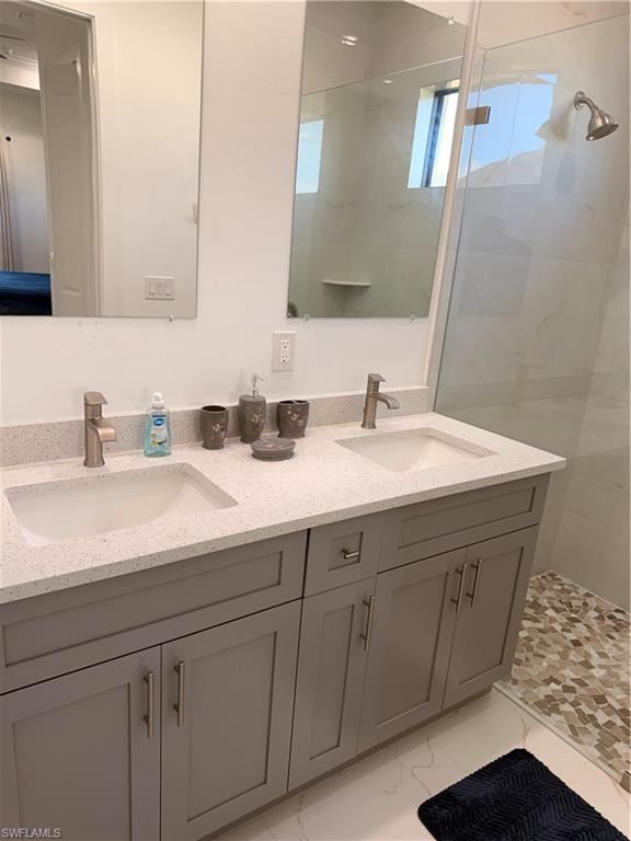 941 Columbus Boulevard Lehigh Acres, FL 33974 - Photo 28 of 41 a bathroom with a sink and a mirror
