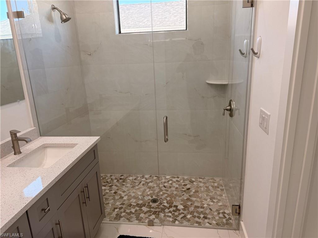 941 Columbus Boulevard Lehigh Acres, FL 33974 - Photo 30 of 41 a bathroom with a sink and a mirror