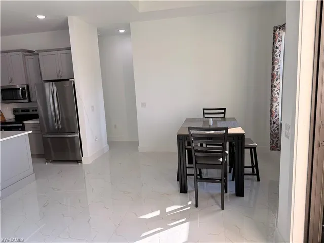 a kitchen with a refrigerator sink and wooden cabinets