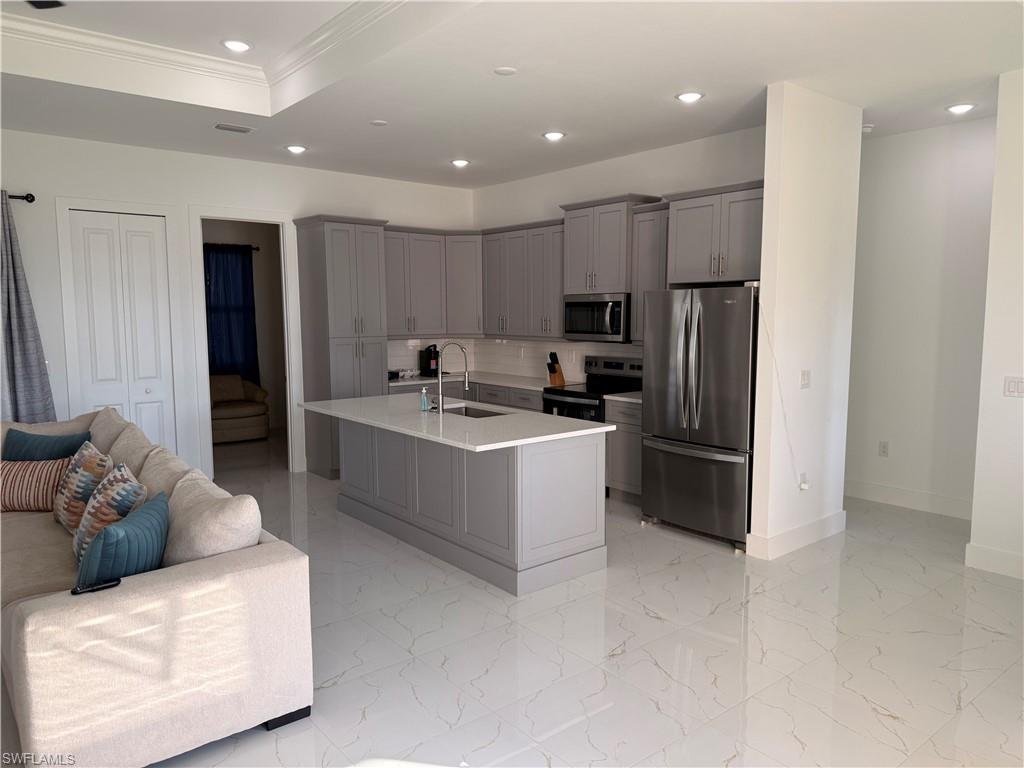 941 Columbus Boulevard Lehigh Acres, FL 33974 - Photo 38 of 41 a kitchen with a refrigerator and a sink