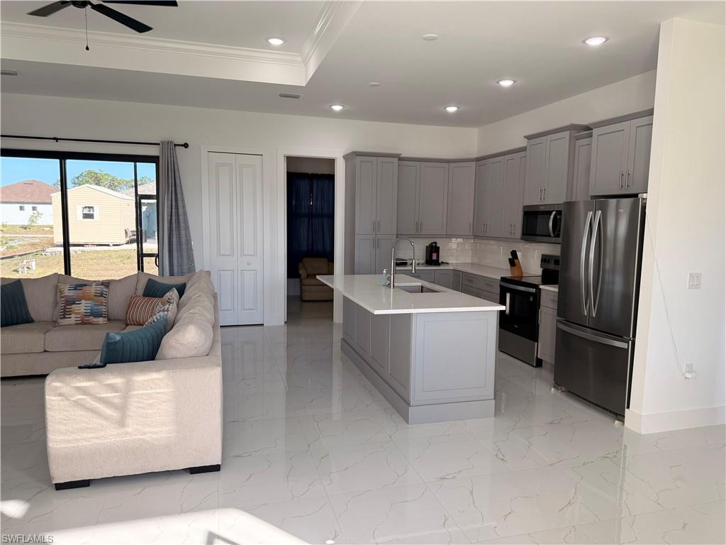 941 Columbus Boulevard Lehigh Acres, FL 33974 - Photo 41 of 41 a living room with furniture and a refrigerator