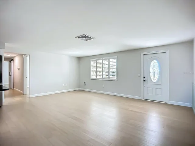 a view of an empty room with a window