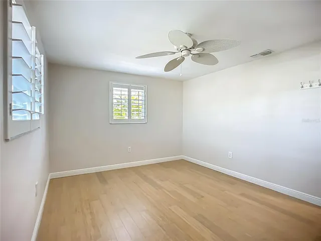 a bathroom with a glass shower door and a window