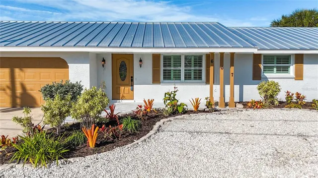 a living room with furniture kitchen view and a wooden floor