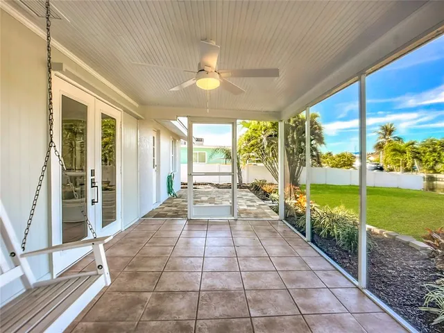 a view of a big house with a big yard and sitting area