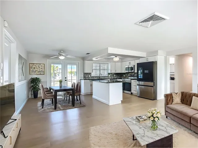 a kitchen with stainless steel appliances granite countertop a sink and stove top oven
