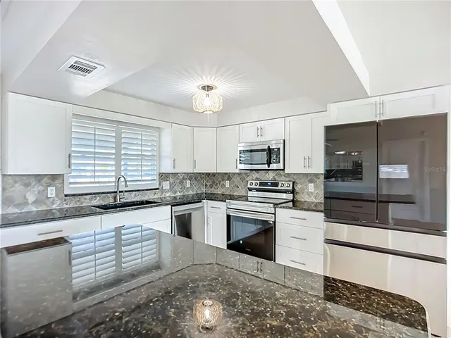 a view of a dining room with furniture and windows