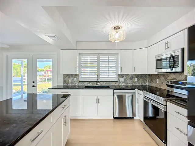 a view of a kitchen with a stove cabinets and wooden floor
