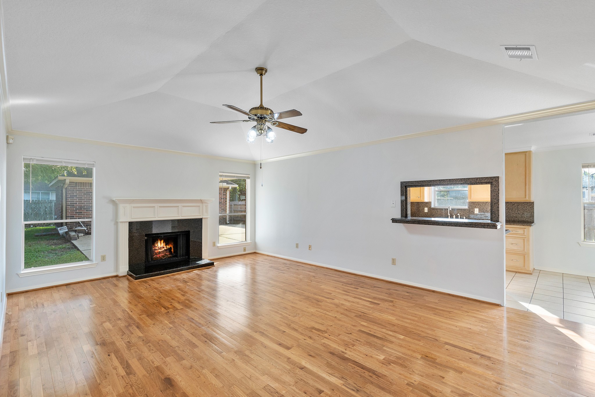 8018 Holiday Lane Houston, TX 77075 - Photo 12 of 42 a view of an empty room with wooden floor fireplace and a window