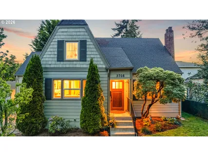 a view of a house with a small yard and potted plants