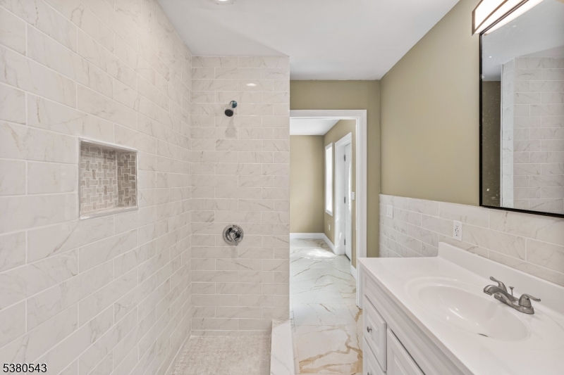 63 Maple Avenue Irvington, NJ 07111 - Photo 14 of 28 a bathroom with a sink and a mirror