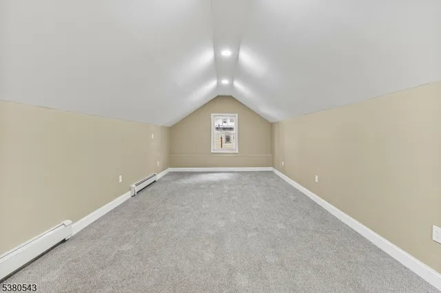 an empty room with a window and a mirror