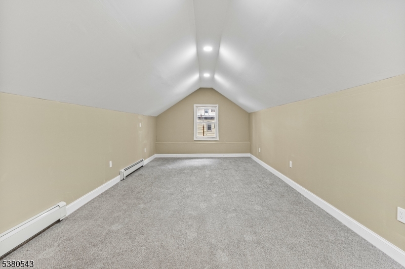 63 Maple Avenue Irvington, NJ 07111 - Photo 15 of 28 an empty room with a window and a mirror