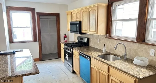 a kitchen with granite countertop a sink and a stove top oven