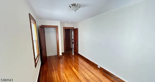 a view of hallway with wooden floor