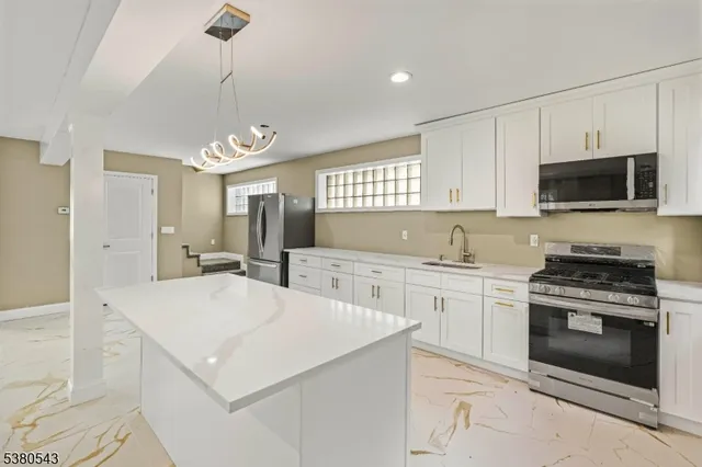 a kitchen with a stove a sink and a refrigerator