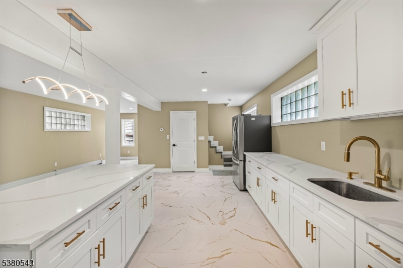 63 Maple Avenue Irvington, NJ 07111 - Photo 10 of 28 a spacious bathroom with a double vanity sink and mirror