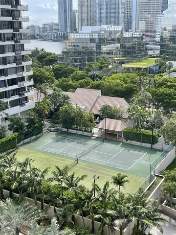 a view of a swimming pool with a lawn chairs and plants