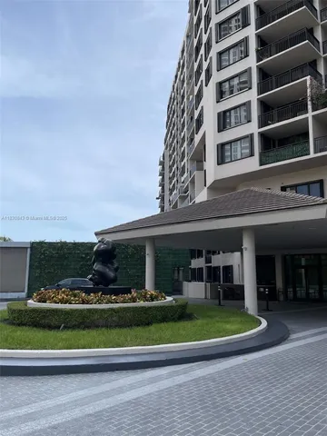 front view of a building with a garden