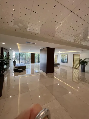 a lobby with furniture and a rug