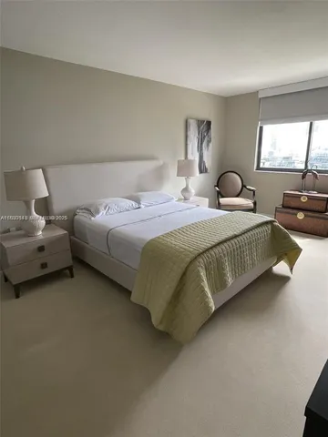 a bedroom with bed and window
