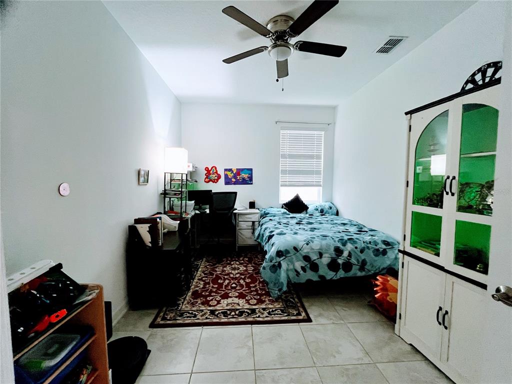 11498 Rhyme Avenue Orlando, FL 32832 - Photo 12 of 17 a bed room with furniture and a window