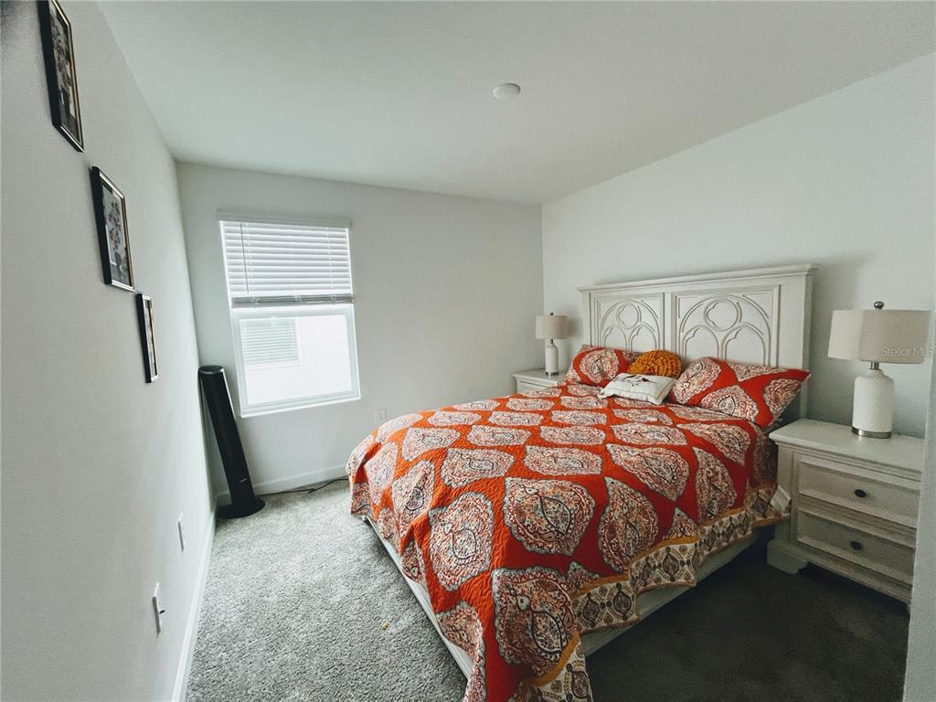 11498 Rhyme Avenue Orlando, FL 32832 - Photo 14 of 17 a bedroom with a bed and a window
