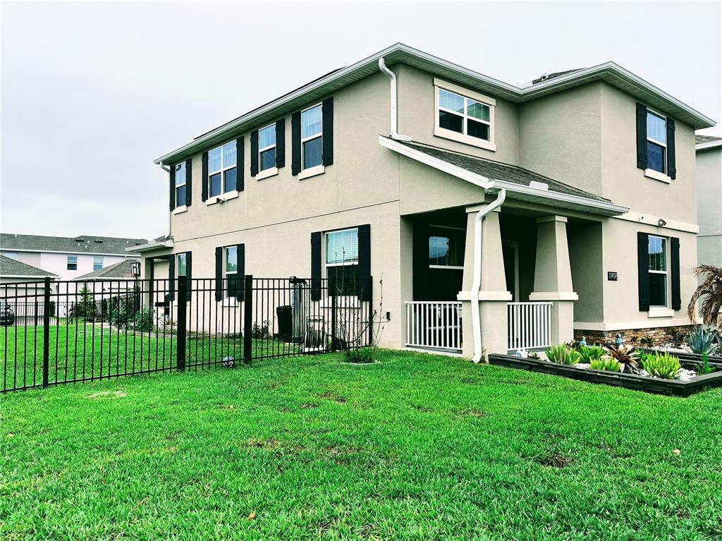 11498 Rhyme Avenue Orlando, FL 32832 - Photo 2 of 17 a front view of a house with a yard