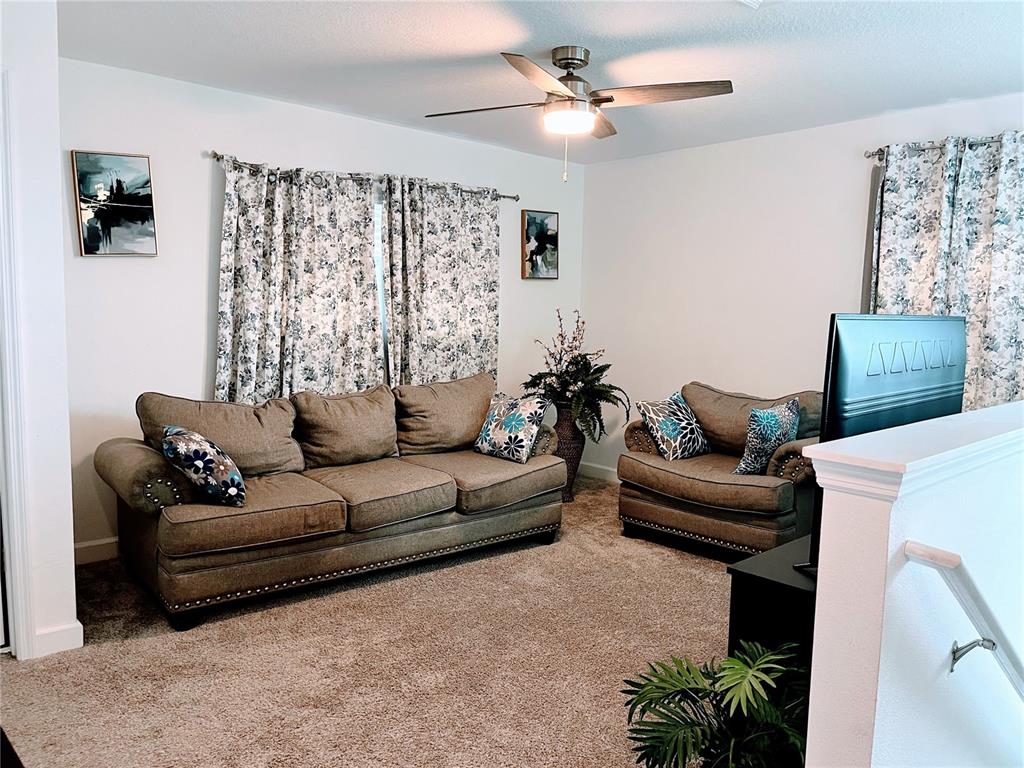 11498 Rhyme Avenue Orlando, FL 32832 - Photo 8 of 17 a living room with furniture and a window