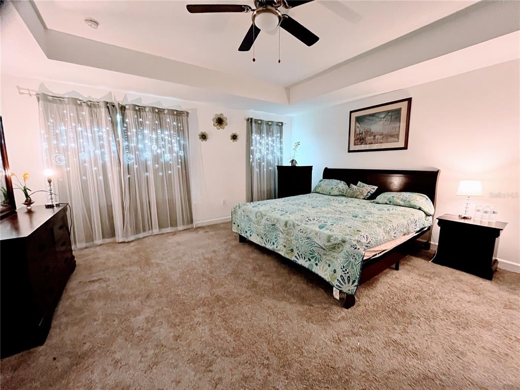 11498 Rhyme Avenue Orlando, FL 32832 - Photo 9 of 17 a bedroom with a bed painting on wall and a large window