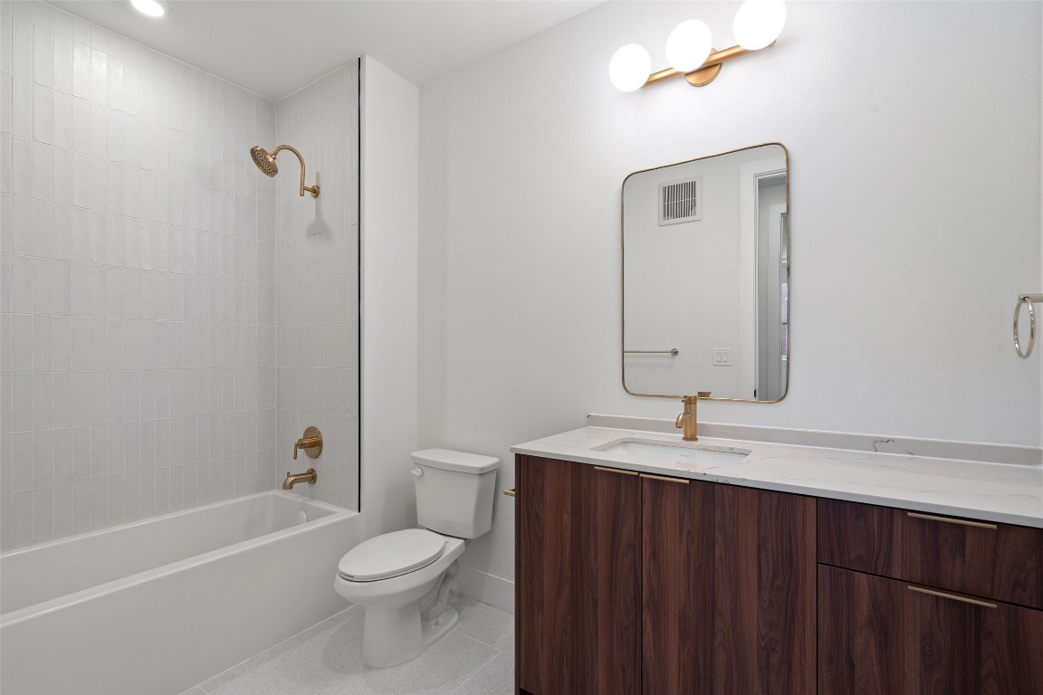 1701 Simond Avenue, Unit 206 Austin, TX 78723 - Photo 14 of 37 a bathroom with a sink a toilet and shower