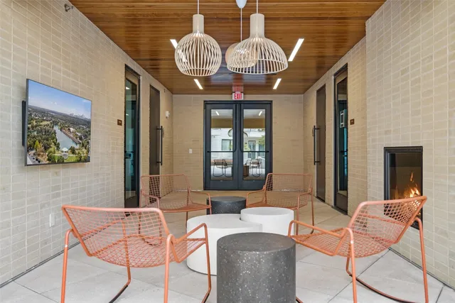 a view of a room with gym equipment and wooden floor